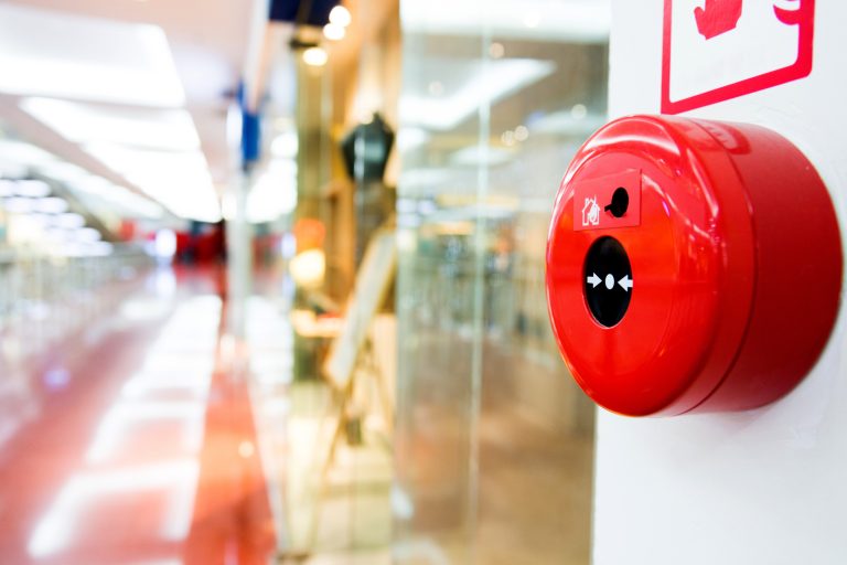 Fire alarm button on wall of shopping center